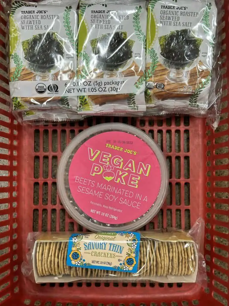 Vegan poke, seaweed, and rice crackers in shopping cart.