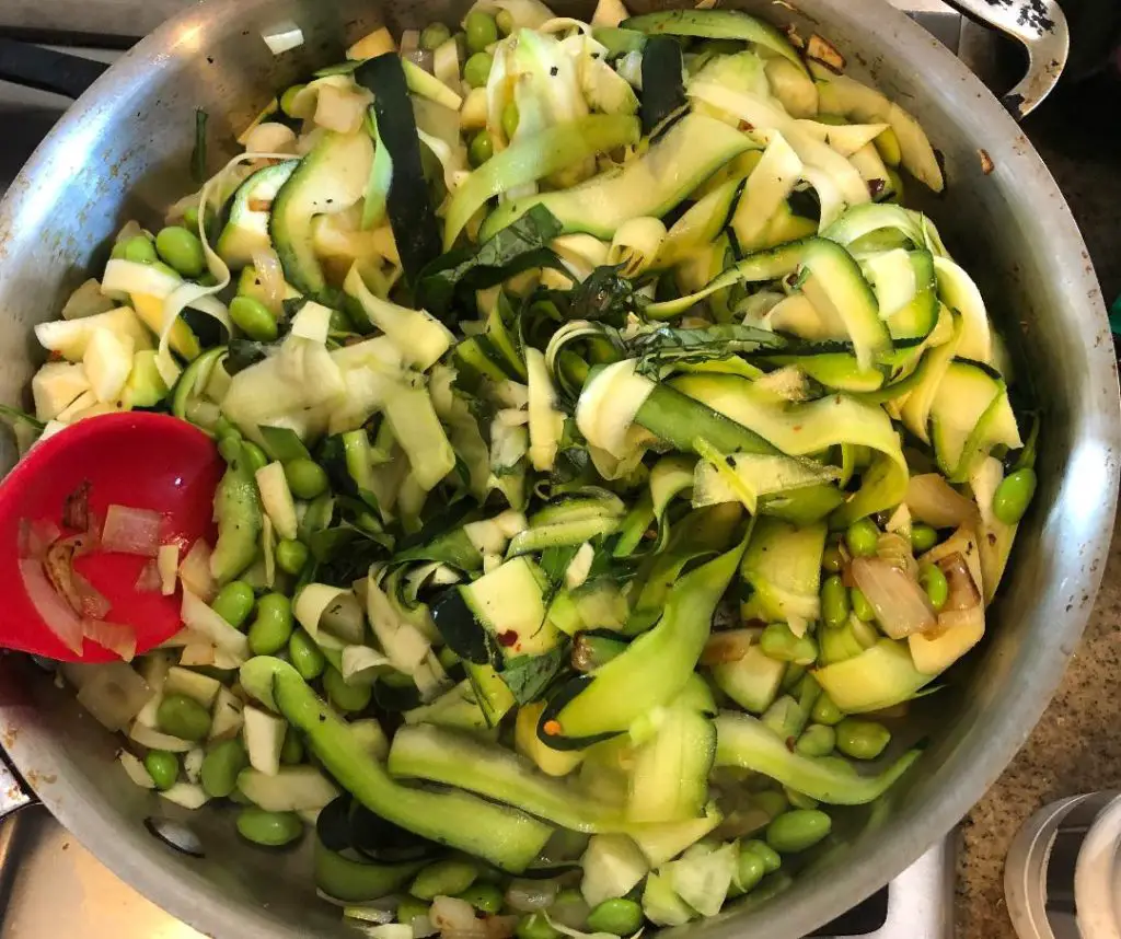 Add veggies to vegan pasta primavera.