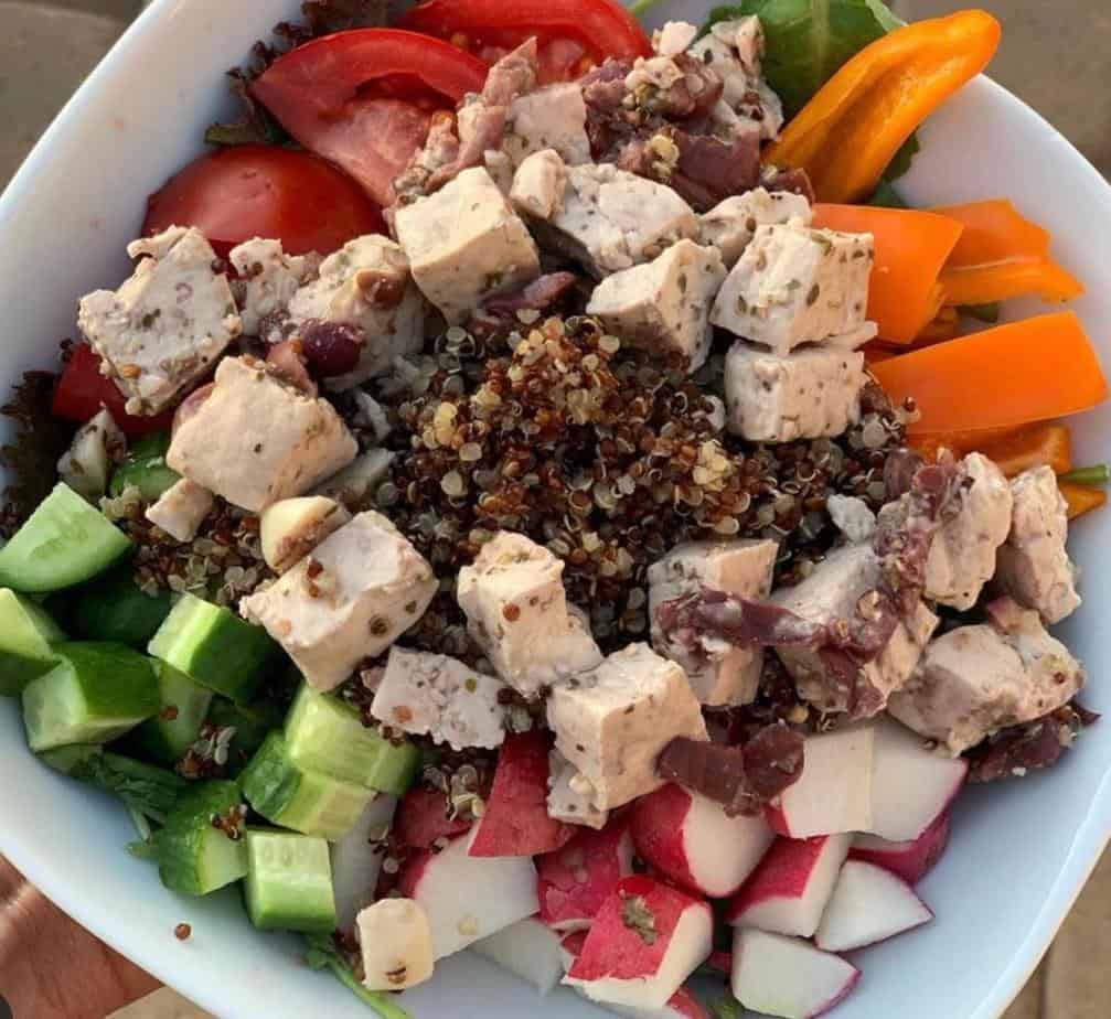 Vegan Greek salad with tofu feta, veggies, and red quinoa.