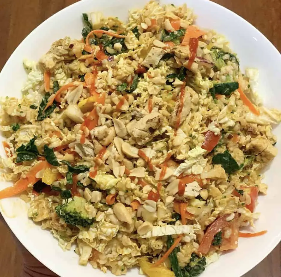 Big bowl of Asian chopped salad with peanuts and vegan chicken.