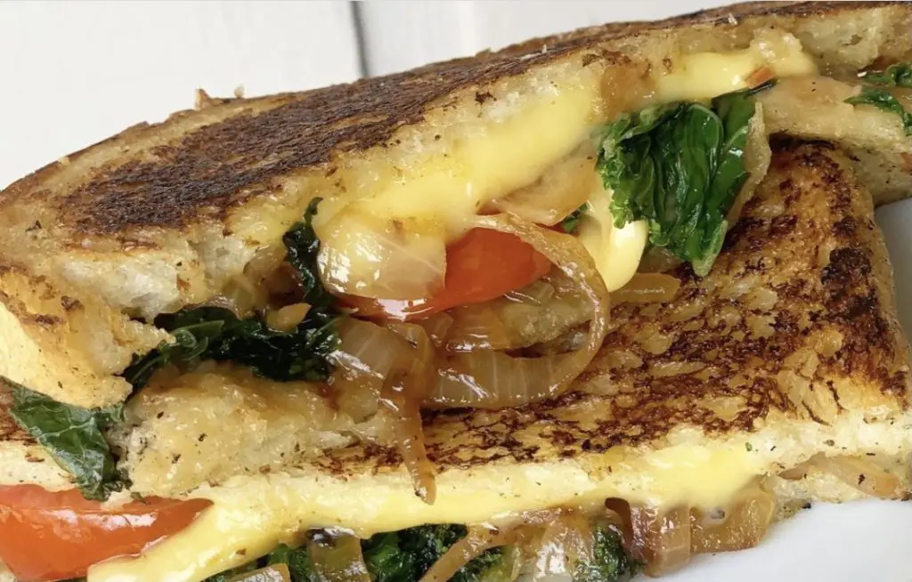 Souped-up grilled cheese for adults, with caramelized onions and greens and tomoatoes. Kids get just cheese.