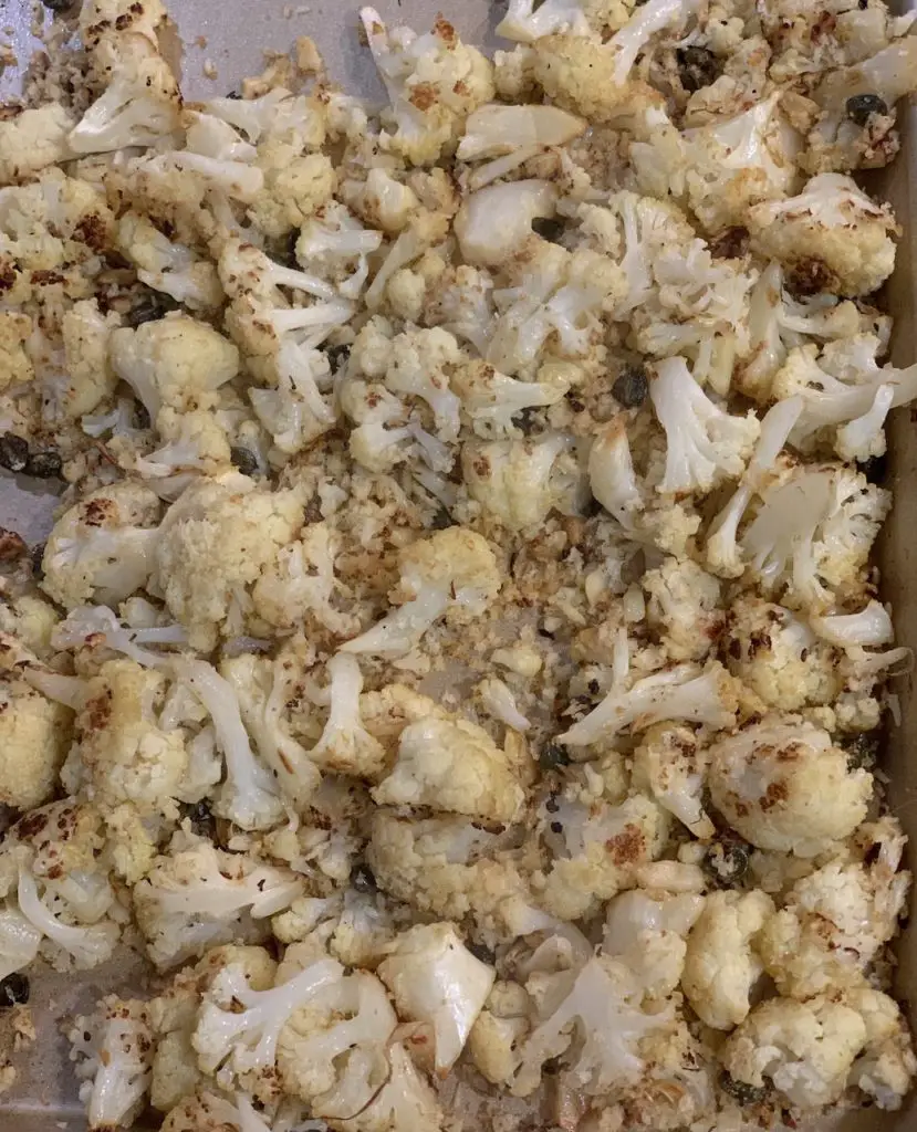 Finished oven roasted cauliflower with garlic, capers & panko, ready for lemon.