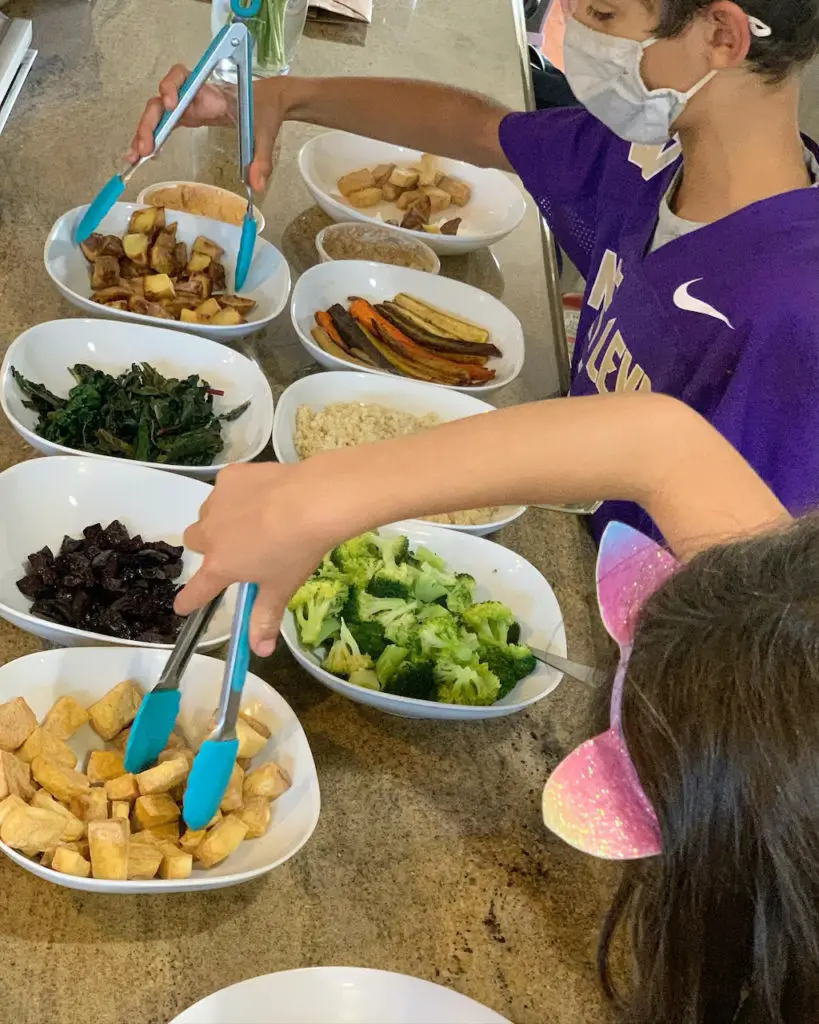 Air fried tofu as part of a buddha bowl bar along with roasted beets, steamed broccoli, air fryer potatoes, quinoa, roasted carrots, steamed greens, and an assortment of dips.