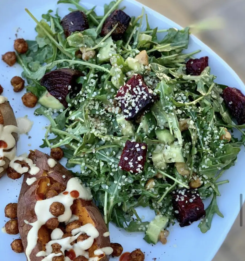 Spicy tahini sauce over sweet potatoes with roasted chickpeas.