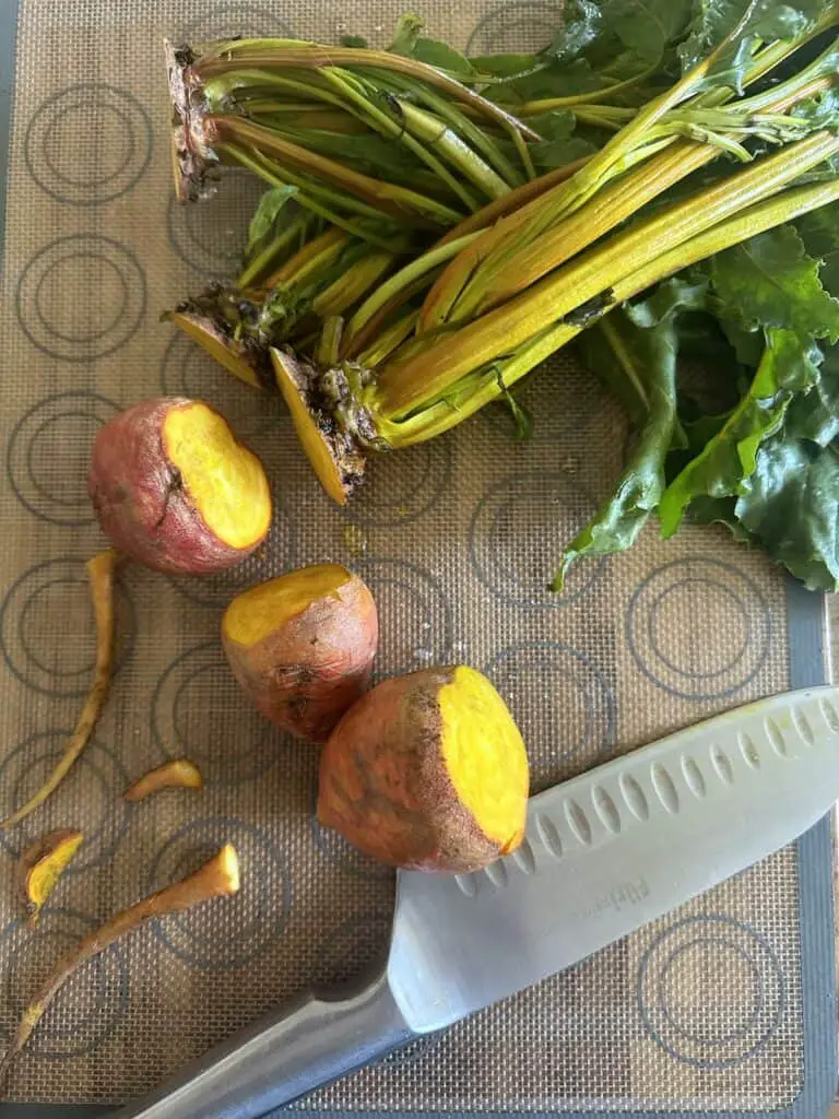 Cutting the stalks off of the beetroot.