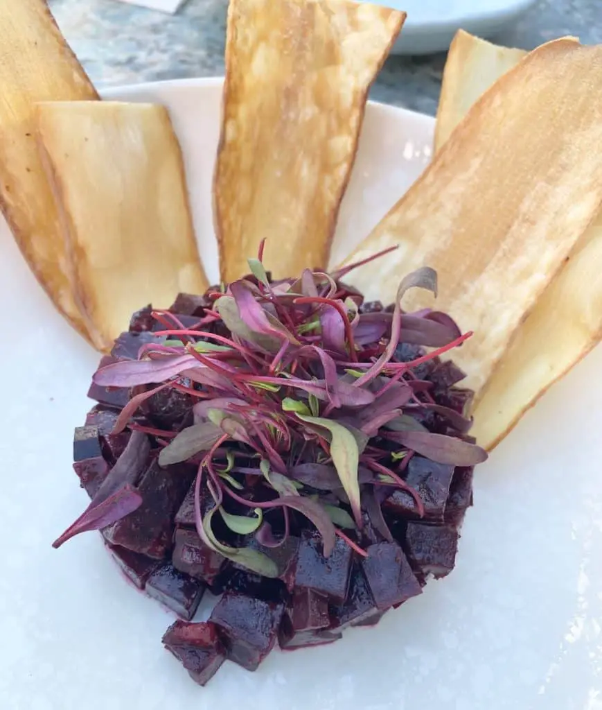 Beautiful beet tartare that looks like a flower on a plate. Served with sweet potato chips.
