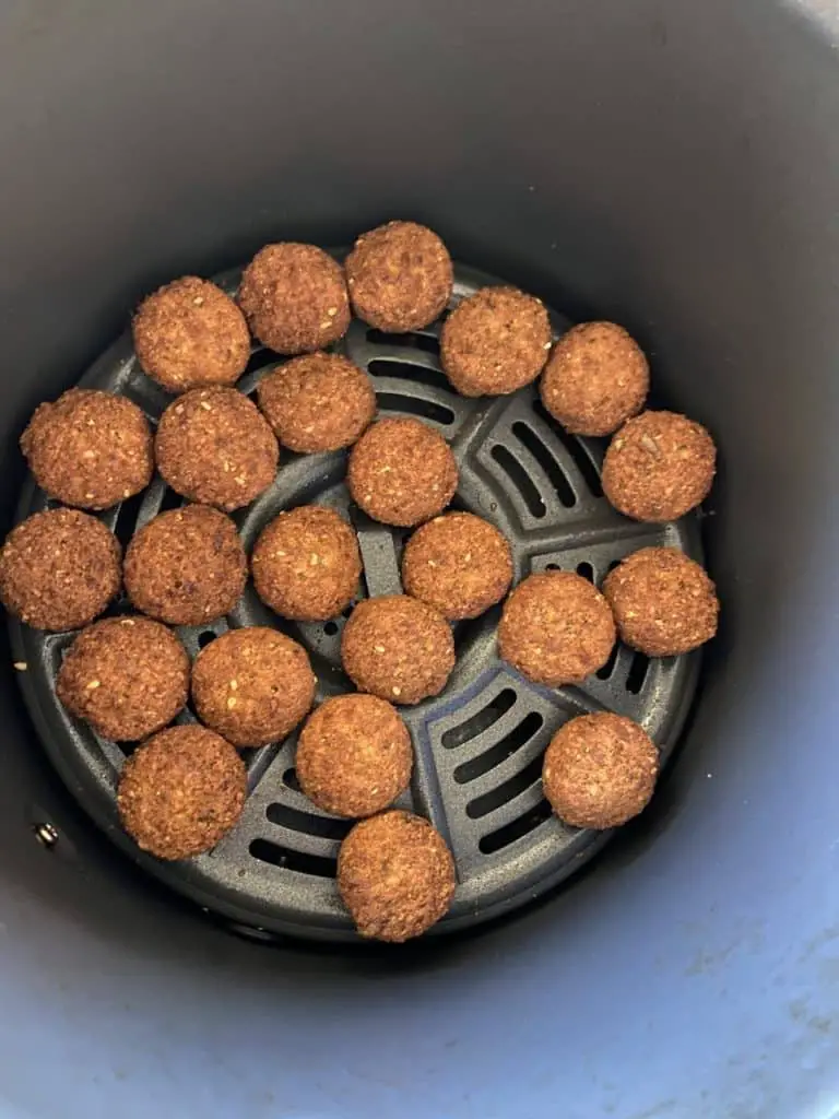 Mini falafel in basket of air fryer.