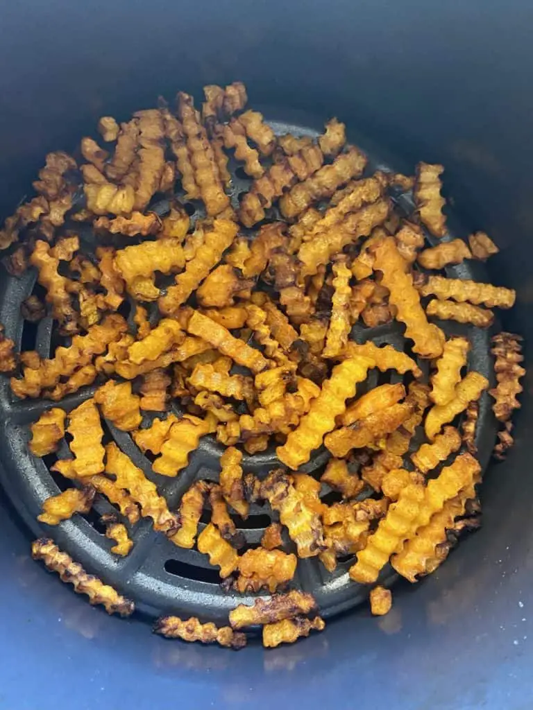 Crispy, crunchy butternut squash fries ready to come out of the air fryer.