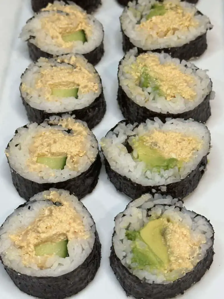 8 pieces of vegan spicy tofu rolls, left side with cucumber, right side with avocado.