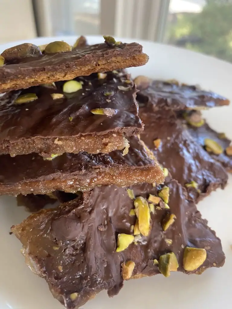 Close up of toffee with pistachios on top.