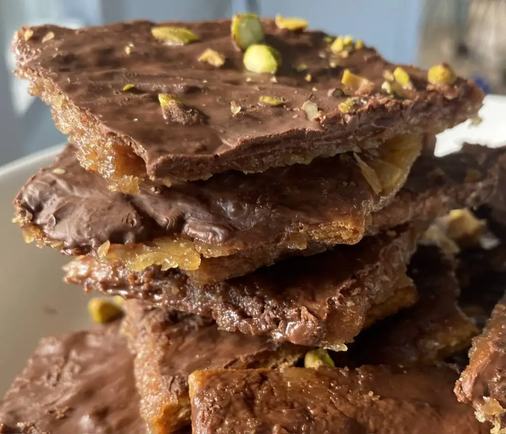 Close-up of vegan toffee with chocolate, nuts, and graham crackers.