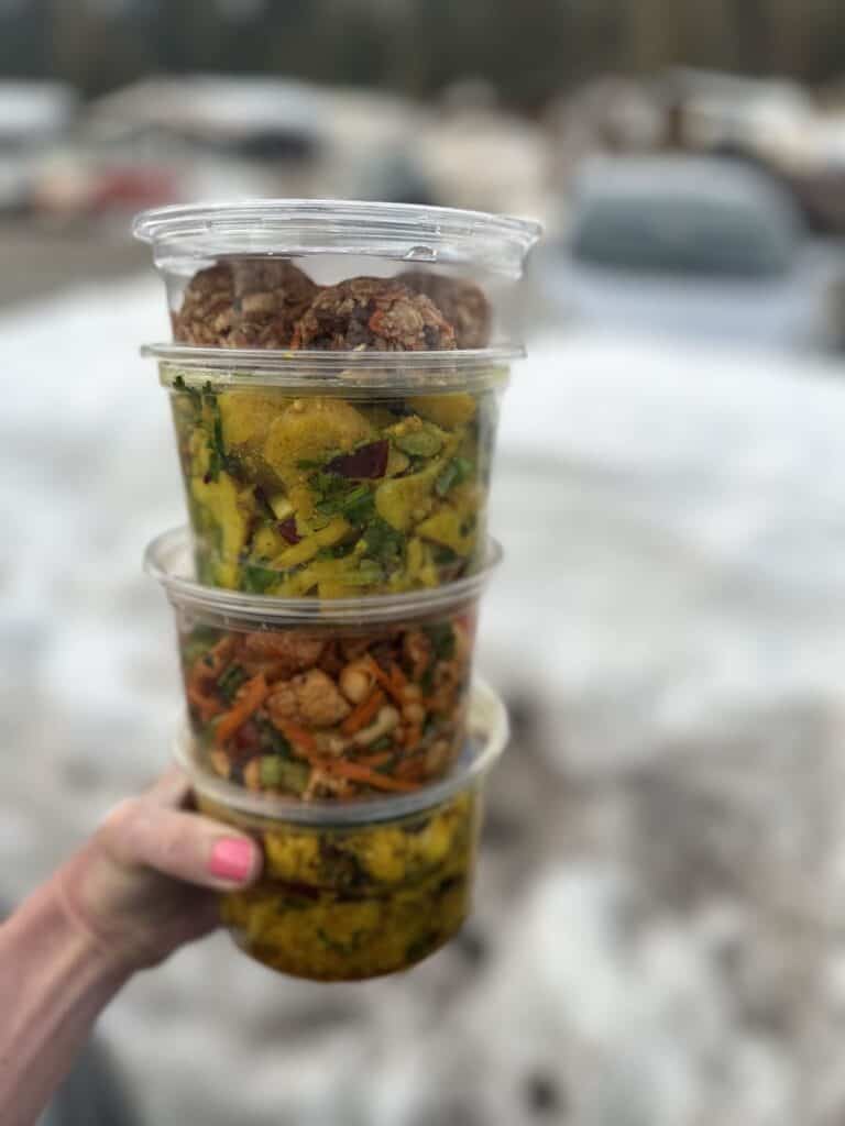 Containers of to-go salads and sides at New Moon Natural Foods.