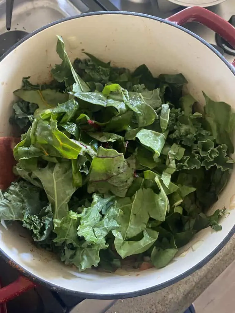 Now the fresh leafy greens are added to the pot.