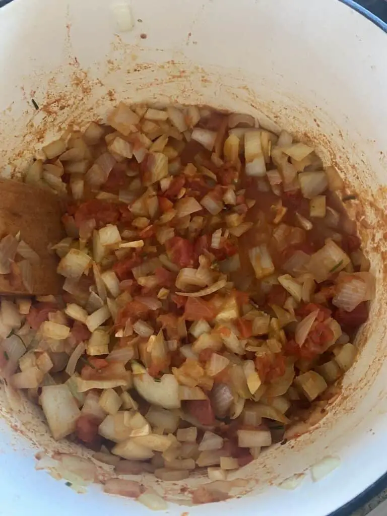 White beans and greens in the making, with tomatoes and spices added.