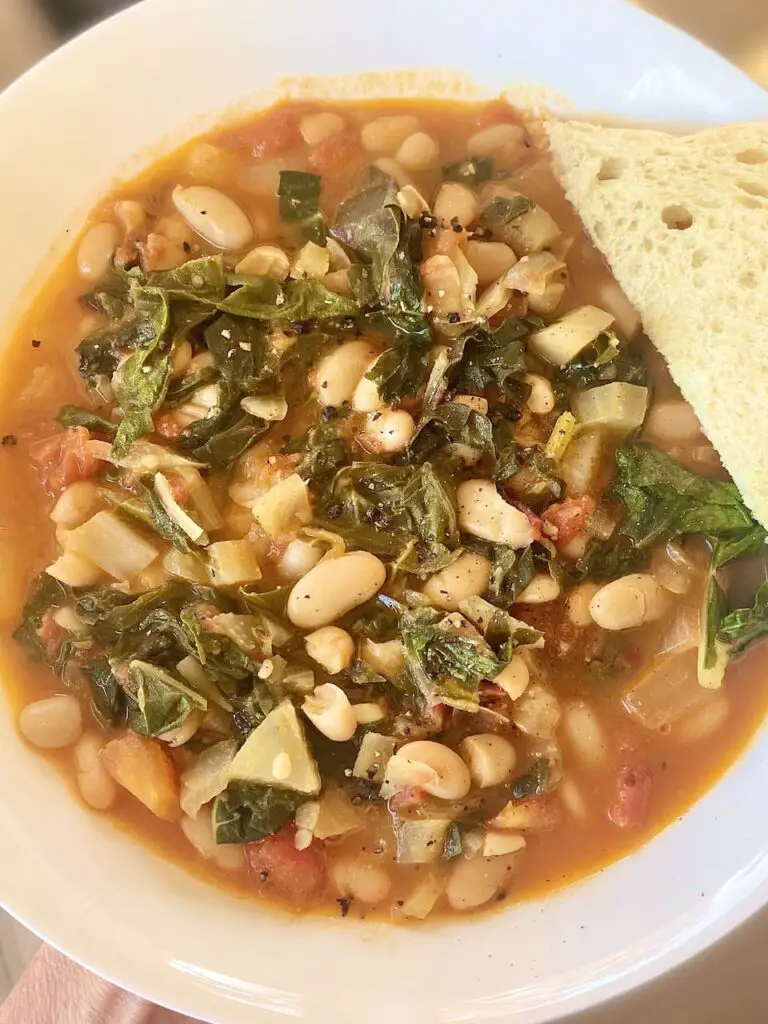 White beans and greens plated with sourdough bread.