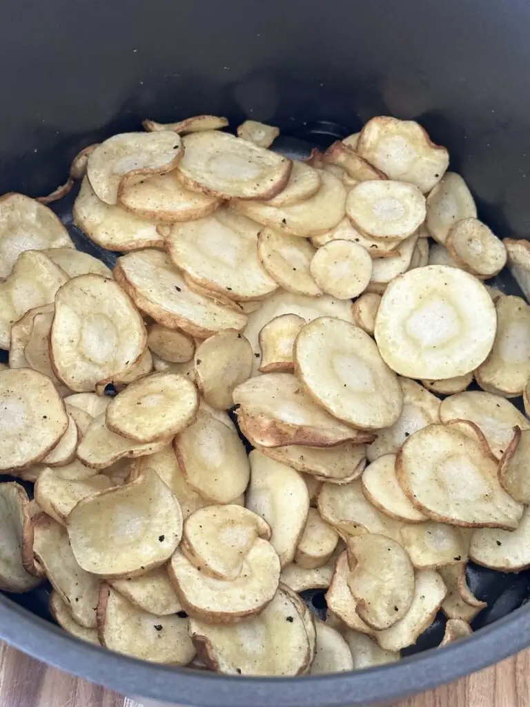 Parsnips are halfway done cooking in air fryer.