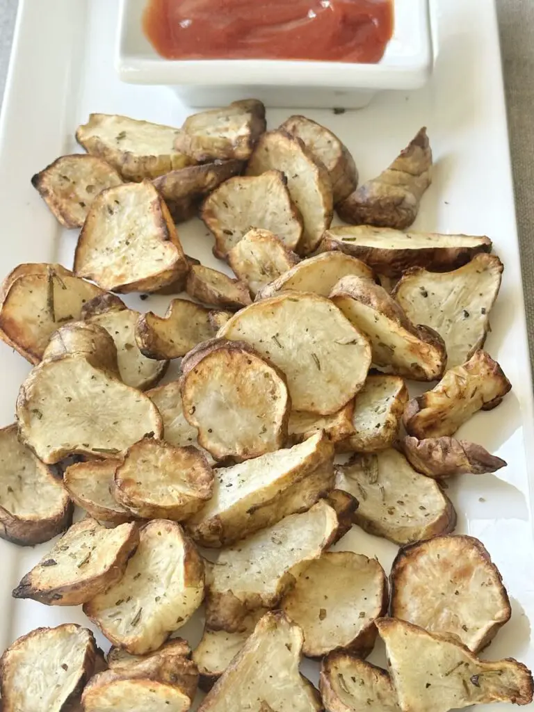 Air fryer sunchokes plated with sriracha ketchup.