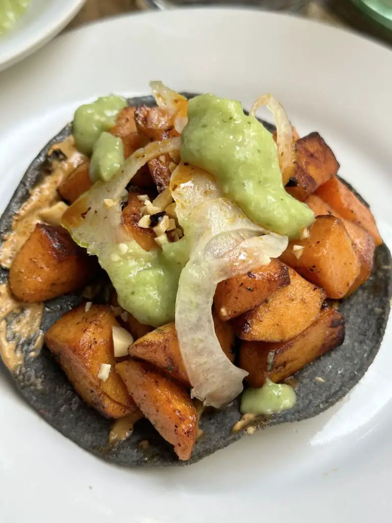Vegan sweet potato tostada on blue tortilla at Contramar in Mexico City.