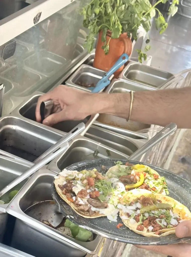 Vegan street food stall Por Siempre Vegana Taqueria, with a line up of toppings.