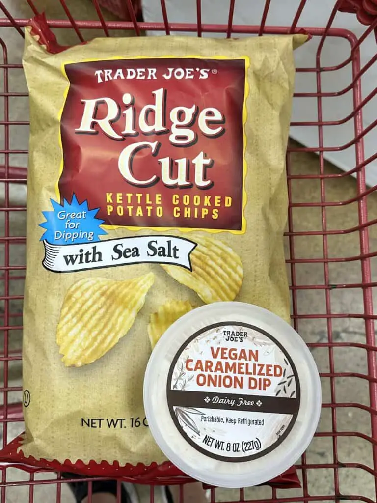 Ridge cut potato chips and vegan caramelized onion dip in shopping cart.