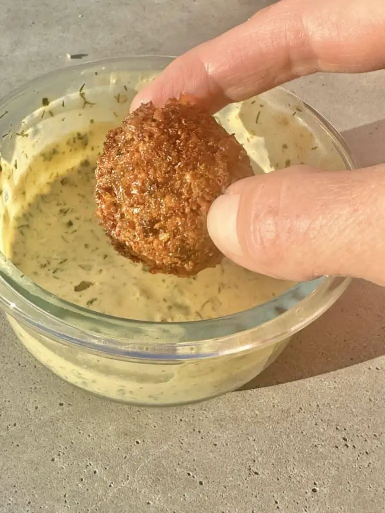 Falafel dipped in lemon herb tahini sauce.