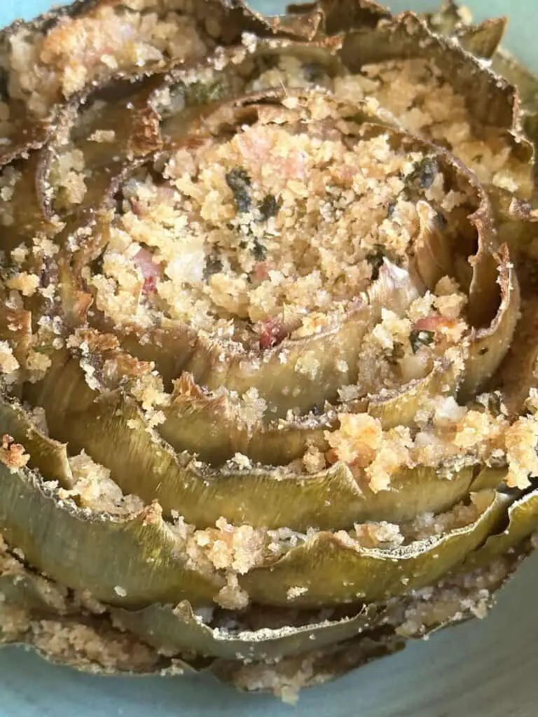 Vegan stuffed artichoke after baking.