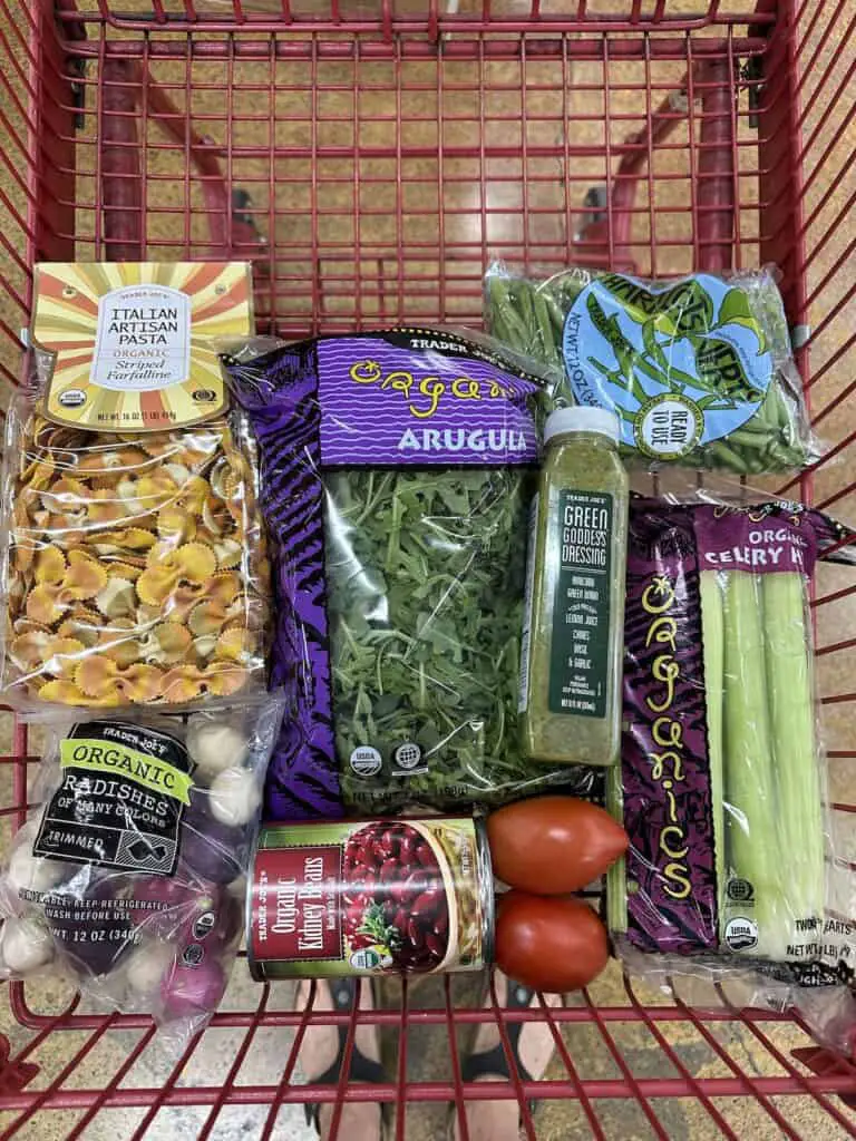 Shopping cart full of pasta salad ingredients.