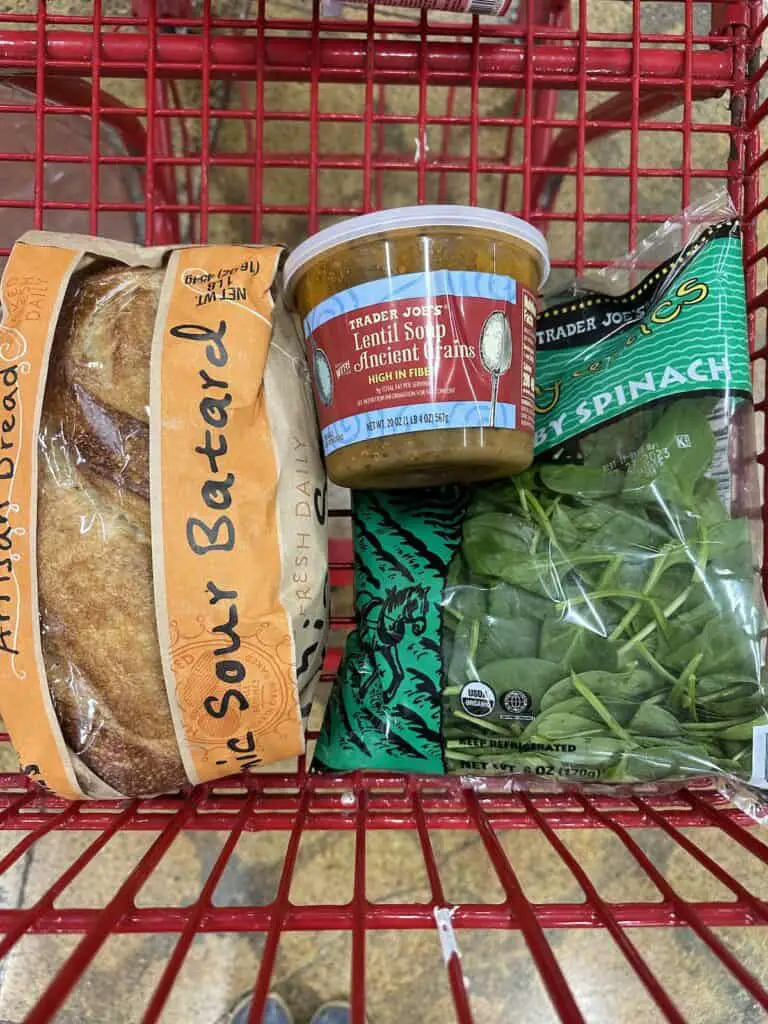 Ingredients for soup with greens in shopping cart.