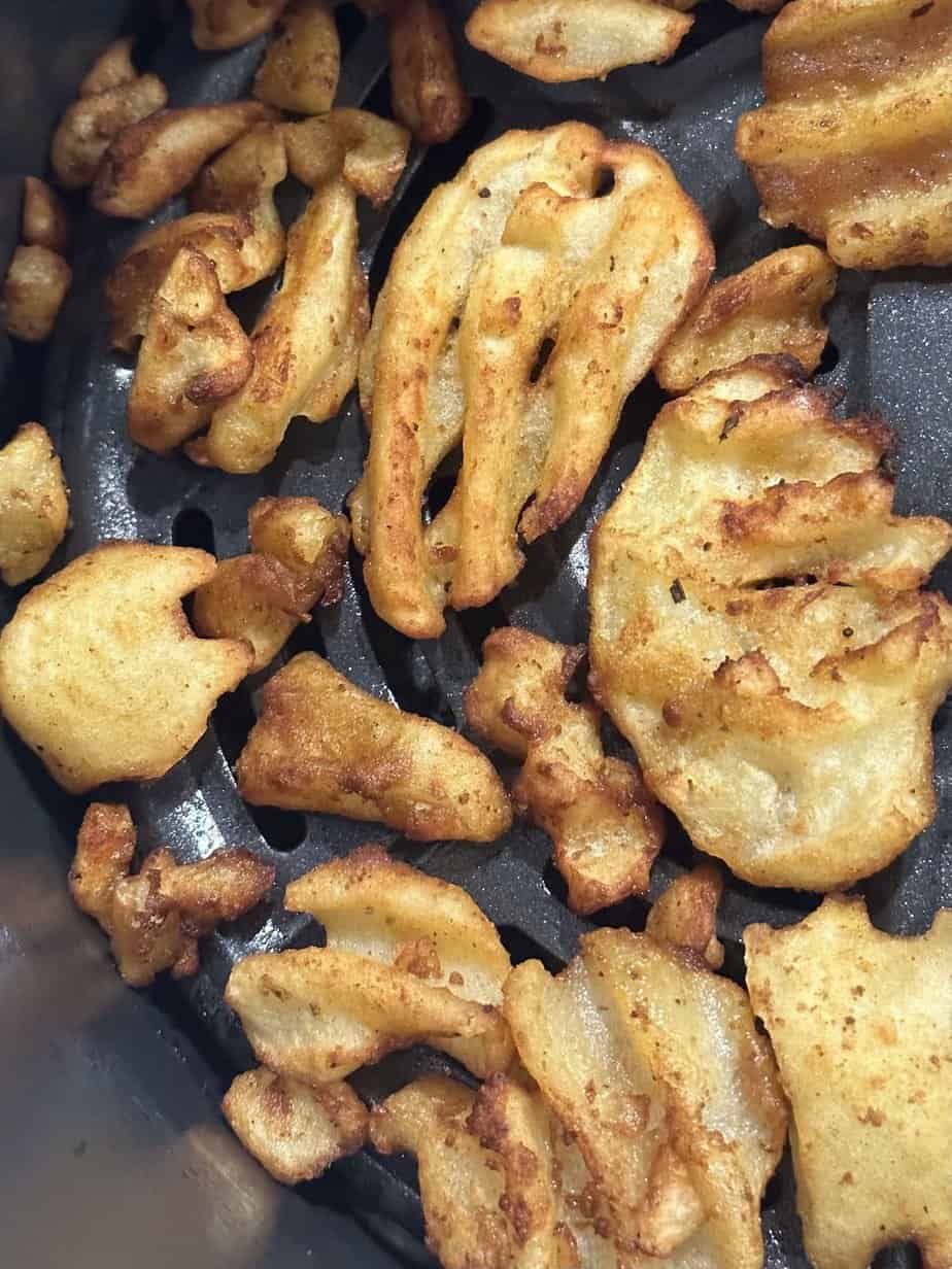 Close up of fries ready to come out of air fryer.