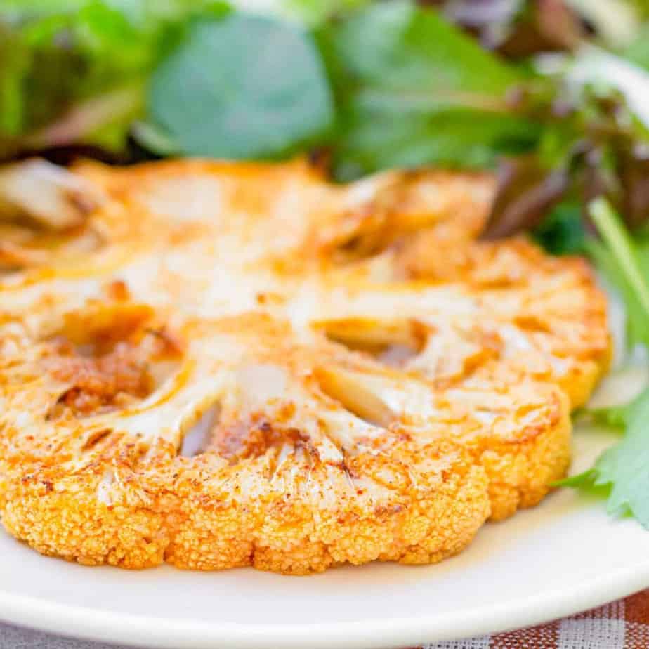 Close up of cauliflower steak on a plate.