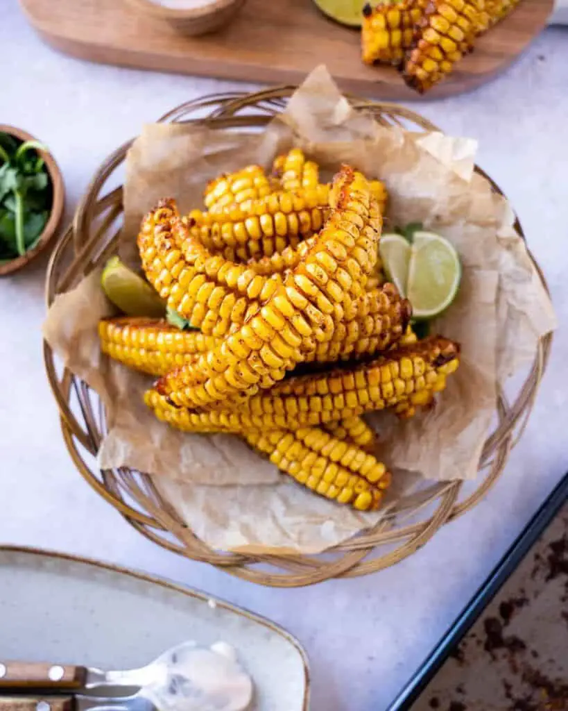 Corn ribs, plated with lime wedges.