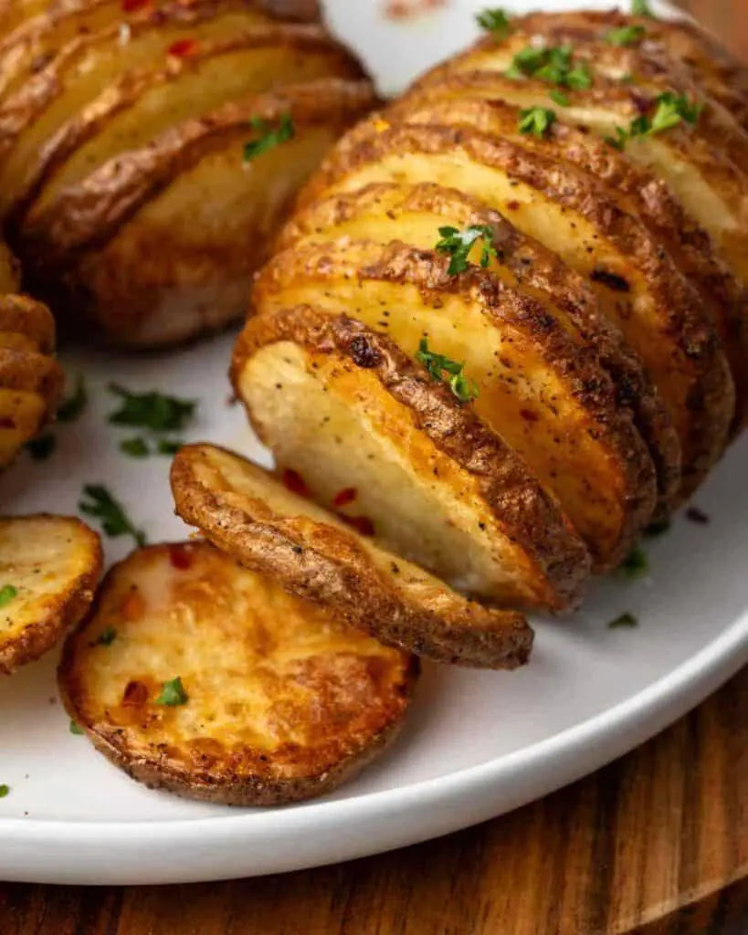 Close up of hasselback potatoes on a plate.
