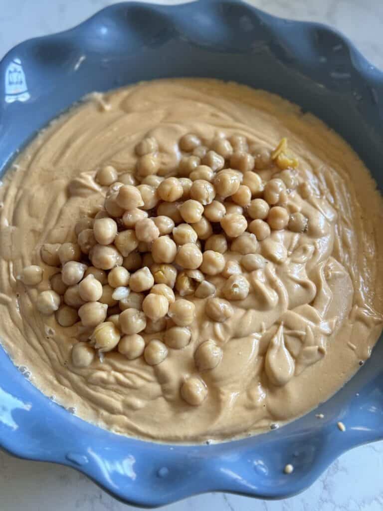 Adding chickpeas into mixture.