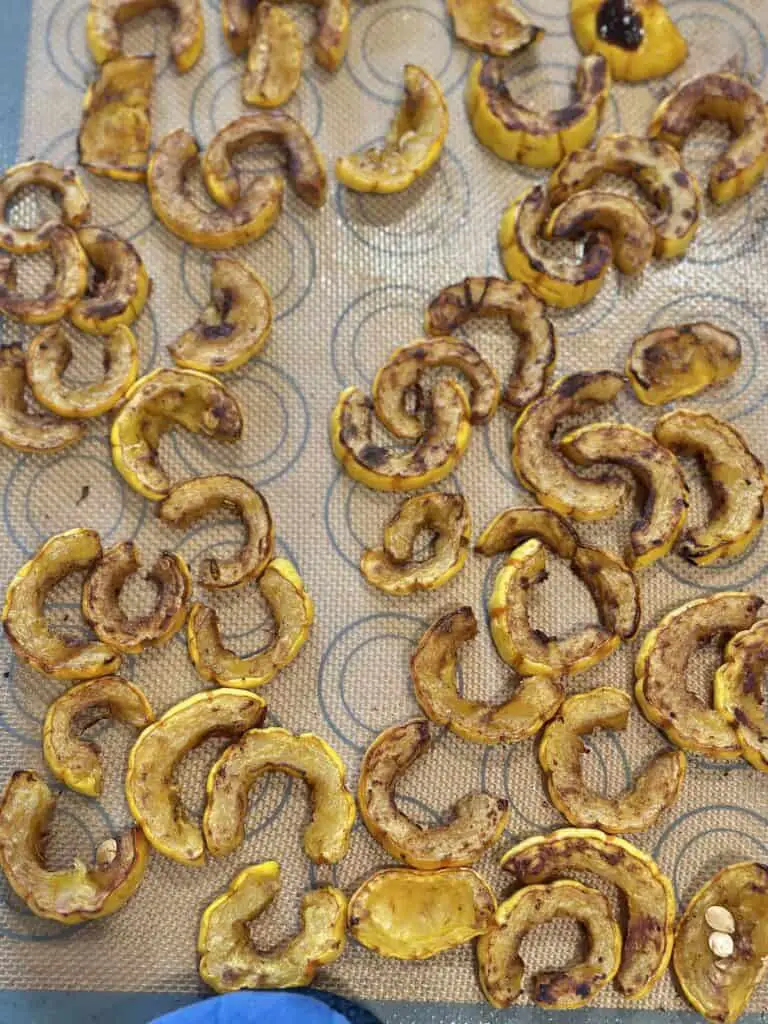 Roasted delicata squash on baking sheet, ready to cool.