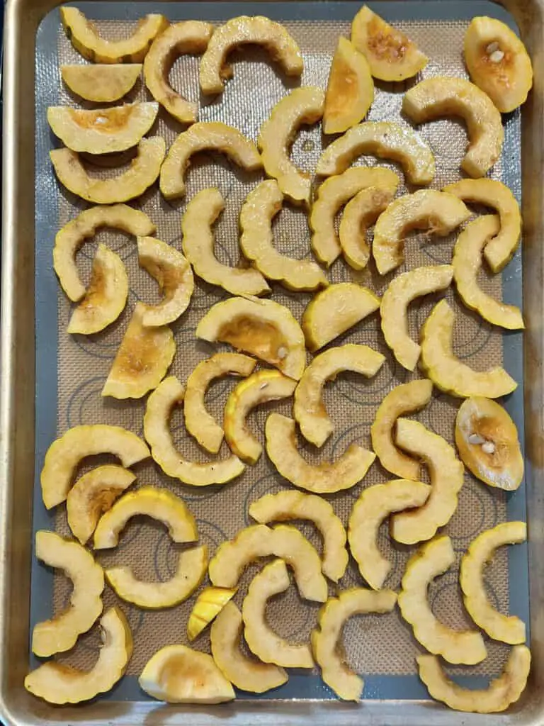 Squash placed on baking sheet and ready to roast.