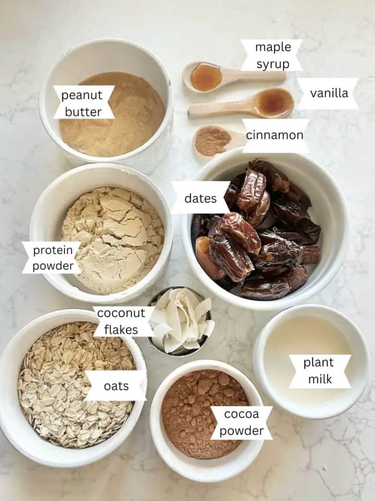 Labeled ingredients for Rich & Chocolatey Vegan Protein Balls recipe on white counter top.